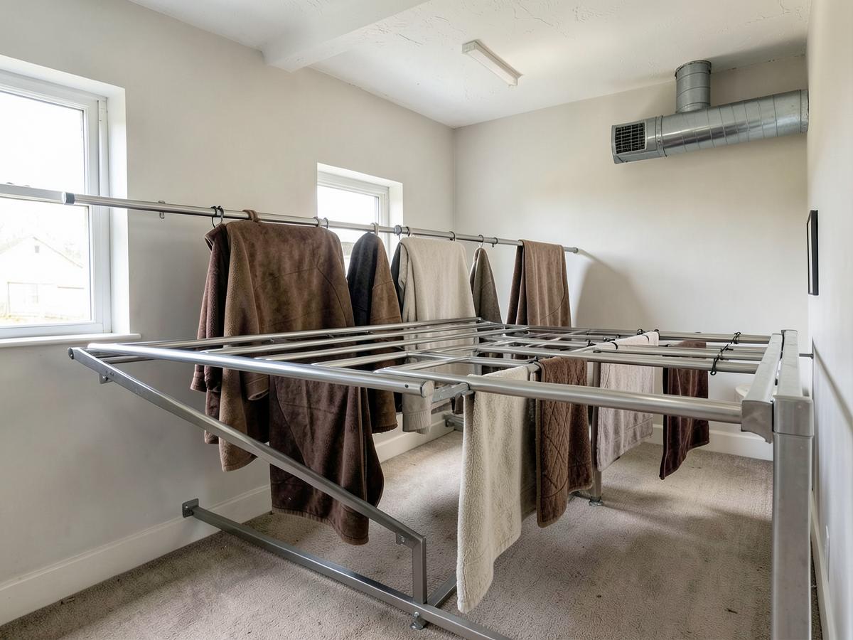Drying room with heated rails and rugs hanging to dry